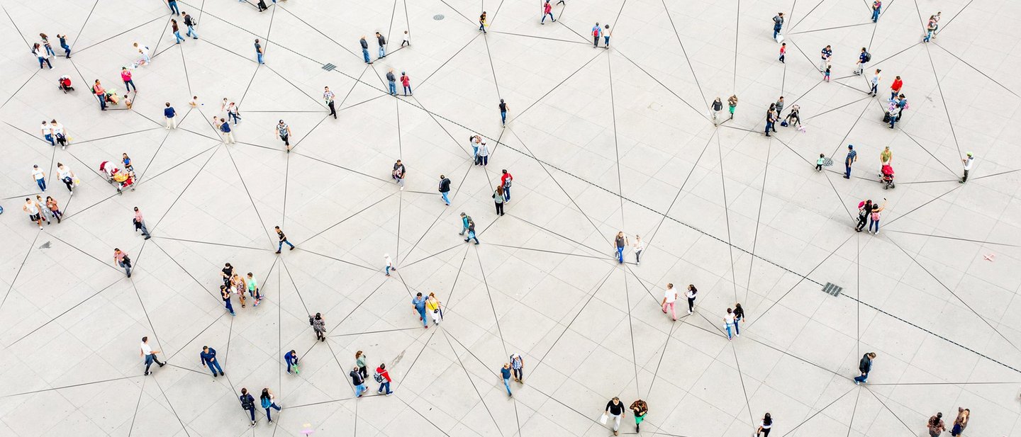 Aerial view of crowd connected by lines symbolizing digital future.