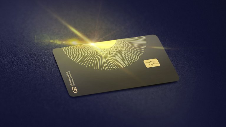A top view of the G+D Ceramic payment card over a black surface