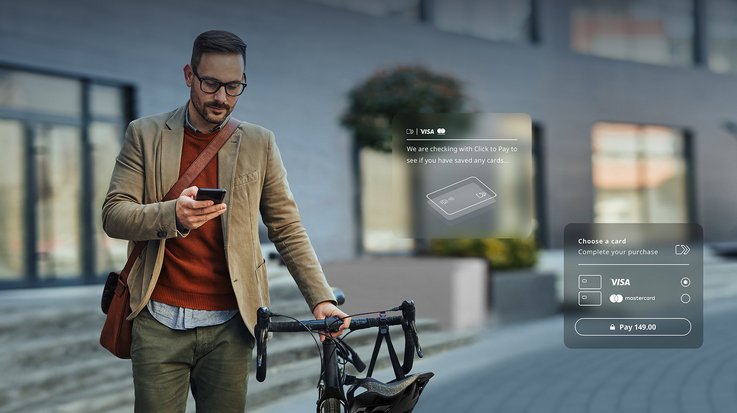 A man pushes his bike and uses his smartphone at the same time.