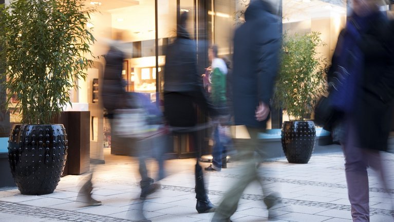 Some people pass in front of a bank building
