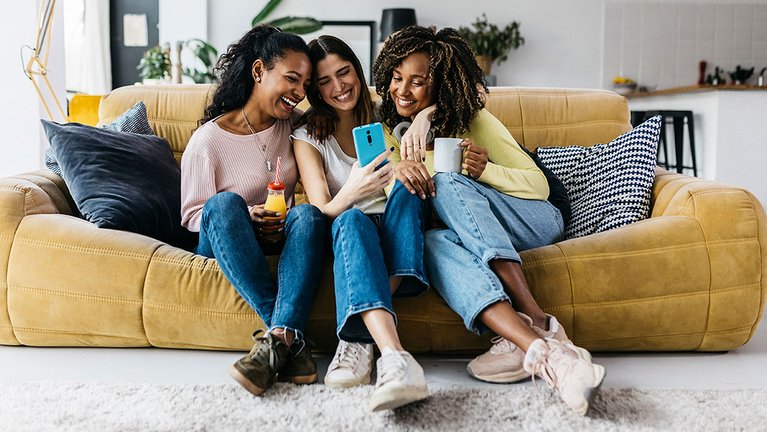 Three friends looking at a smartphone