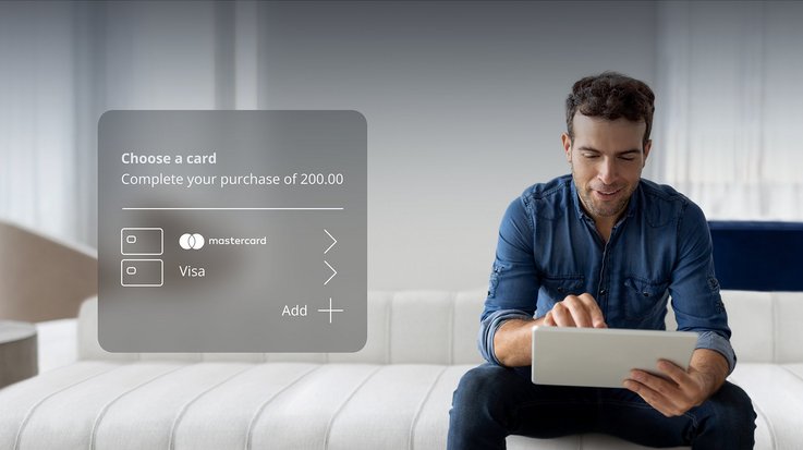 A man with tablet and digital overlay of payment card selection