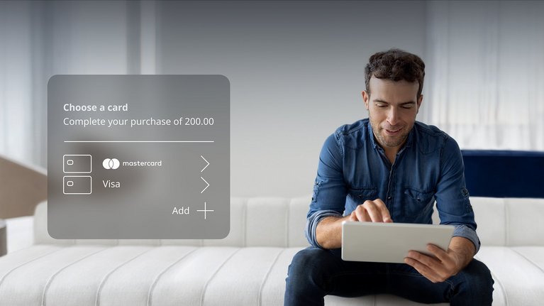 A man with tablet and digital overlay of payment card selection