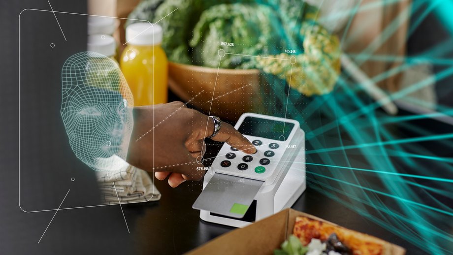 a person paying on a card machine with visuals