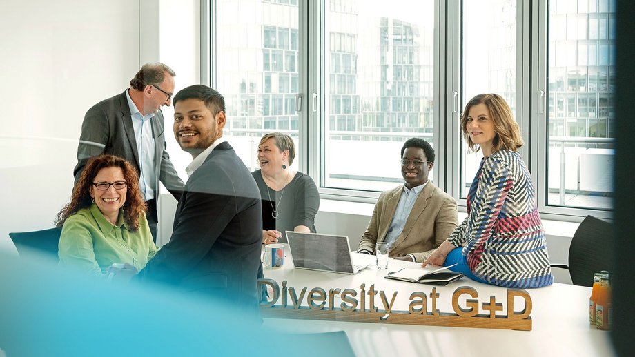 group of happy people sitting in a conference room