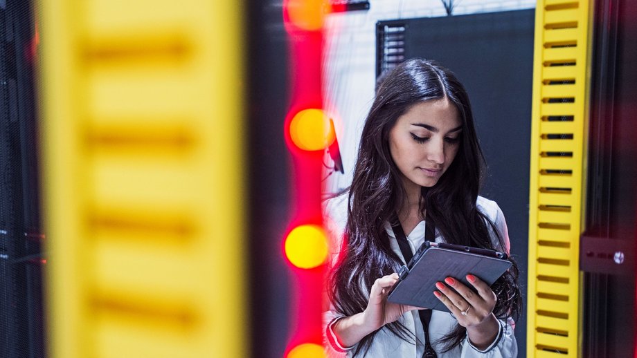 a women with a tablet in a server room