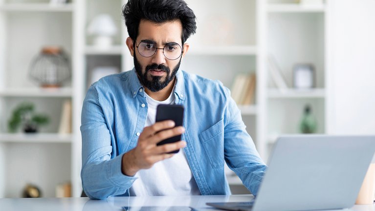 Person looks irritated on their smartphone