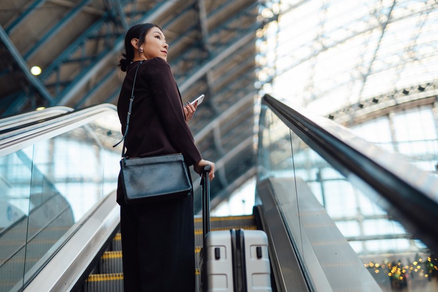 Woman travelling with cellphone at airport