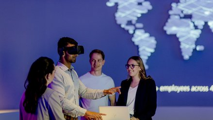 Team working with interactive technology and global network diagram in the background