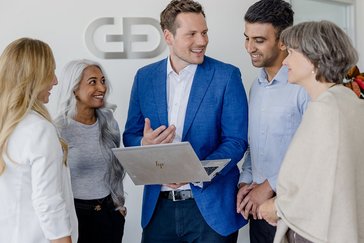 Group of colleagues discussing together in the office