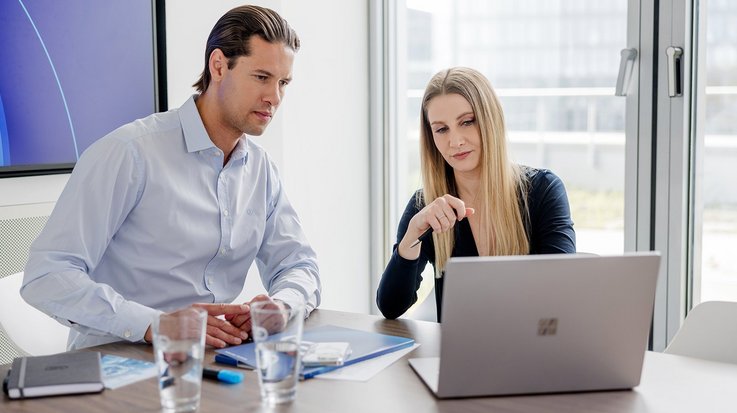 Two colleagues working on laptop