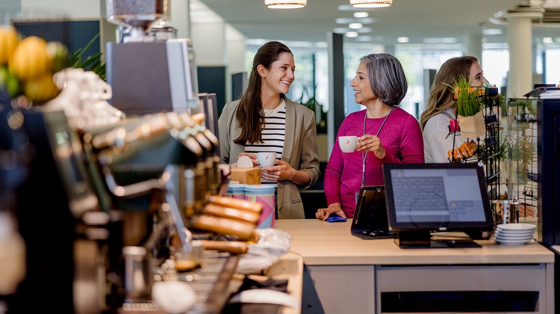 Employees having coffee and conversation in the canteen