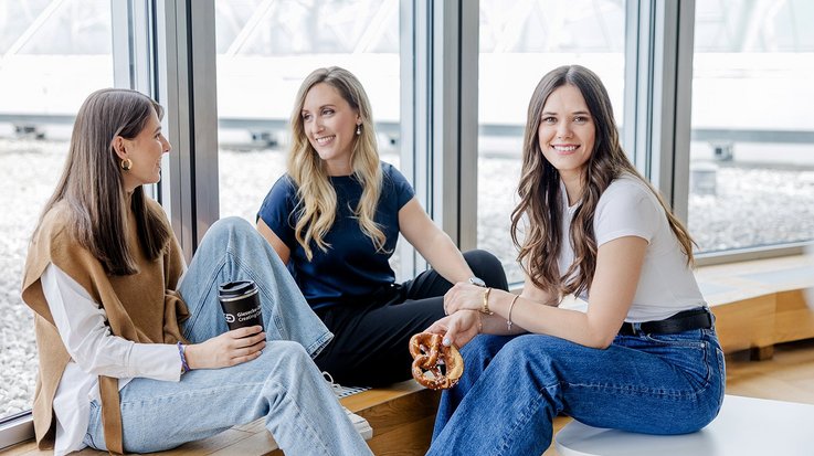 Colleagues relaxing with coffee and pretzel