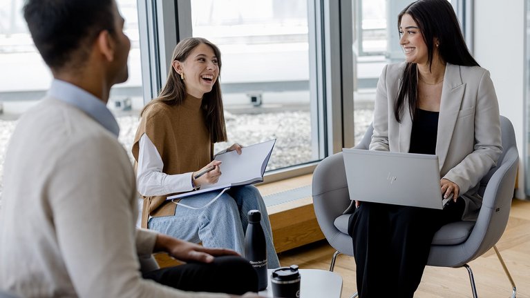 Team meeting with laptop and notes