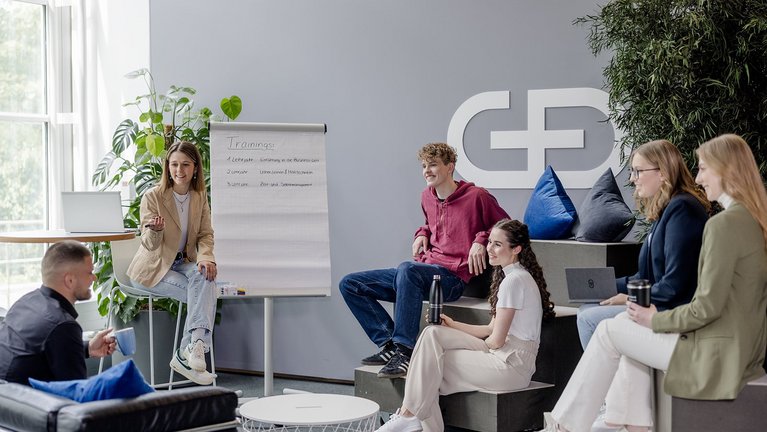 Team meeting in modern office with flipchart and laptop