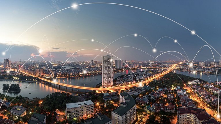 Cityscape with data connection lines arching over the sky