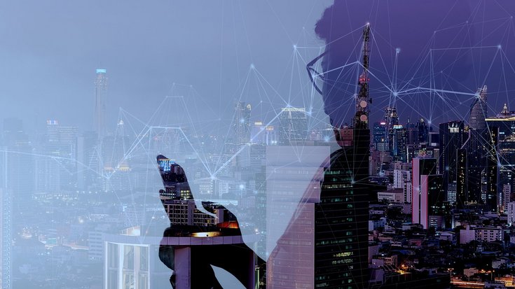 Double exposure of a person and a connected city skyline