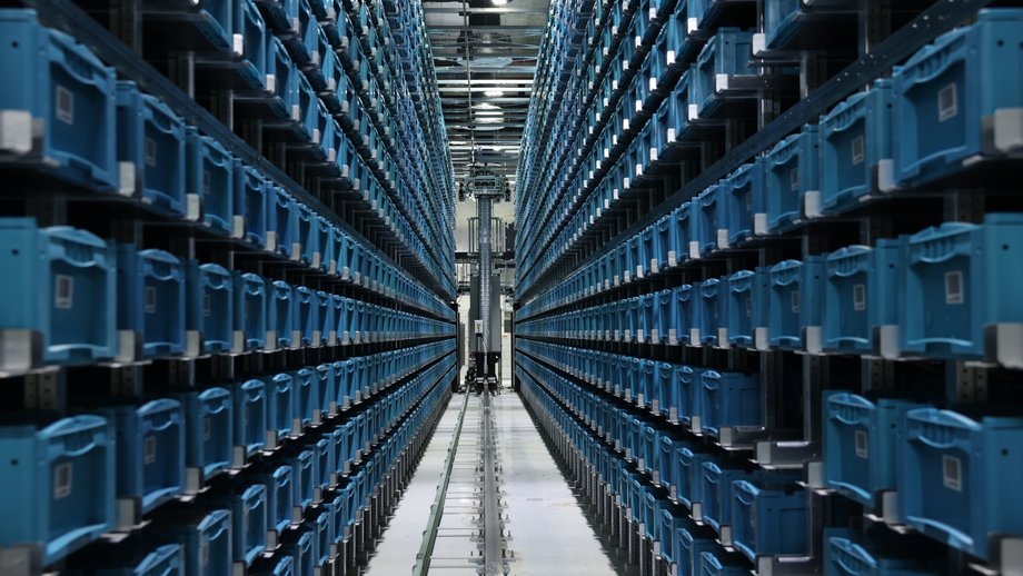 Automated storage system with blue bins at the Casa do Kwanza Cash Center in Luanda.