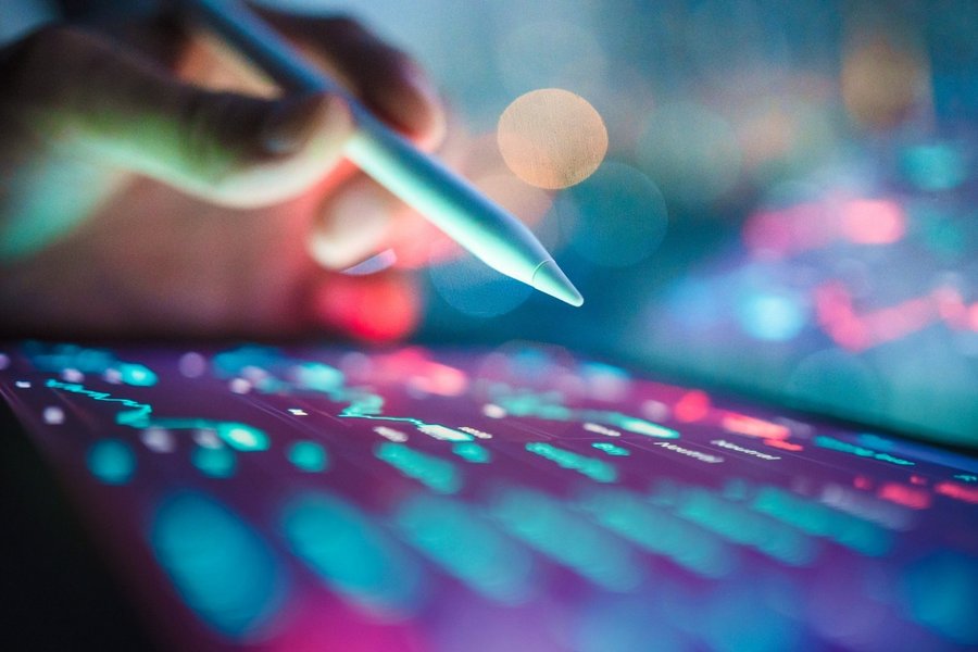 Business technology coding with prompting into an AI assistant on a tablet with digital pen