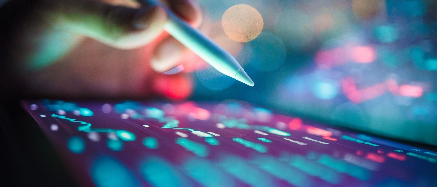 Business technology coding with prompting into an AI assistant on a tablet with digital pen