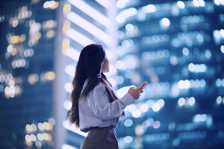 Women with mobile phone in urban surroundings