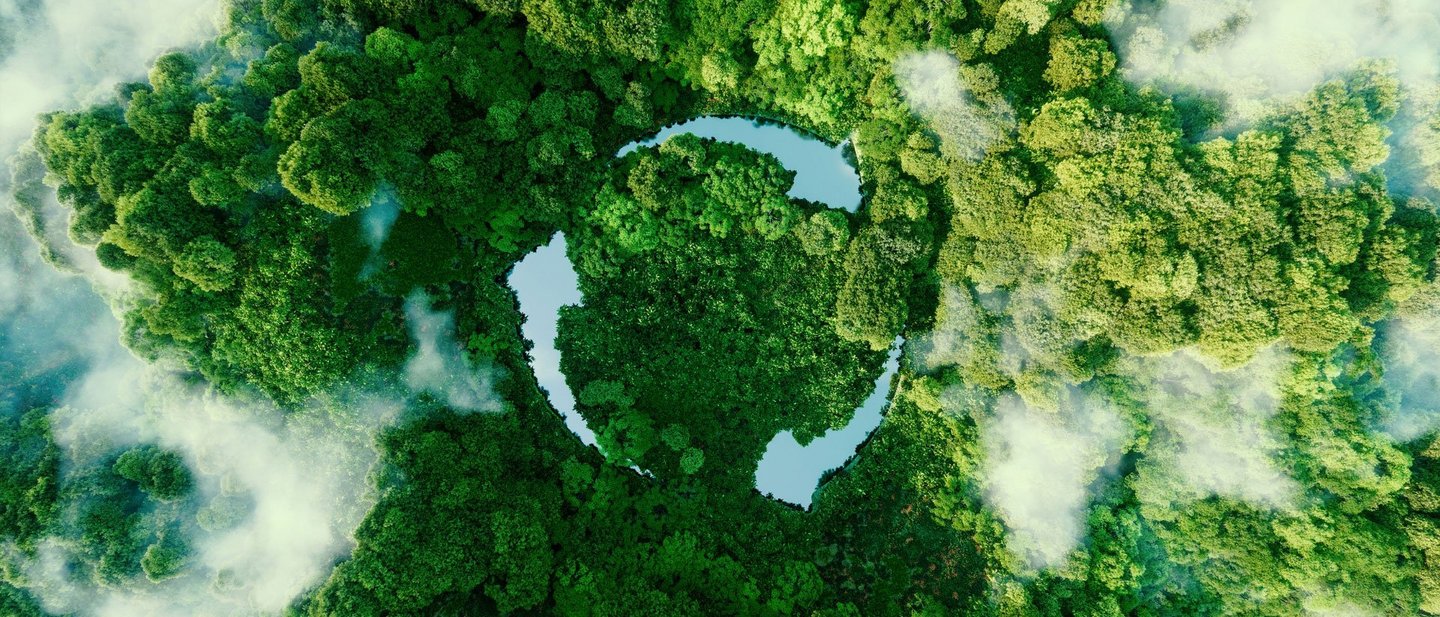 Three ponds arranged as arrows, amidst green trees, form the recycling symbol
