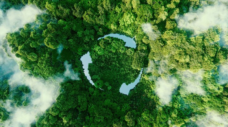 Three ponds arranged as arrows, amidst green trees, form the recycling symbol