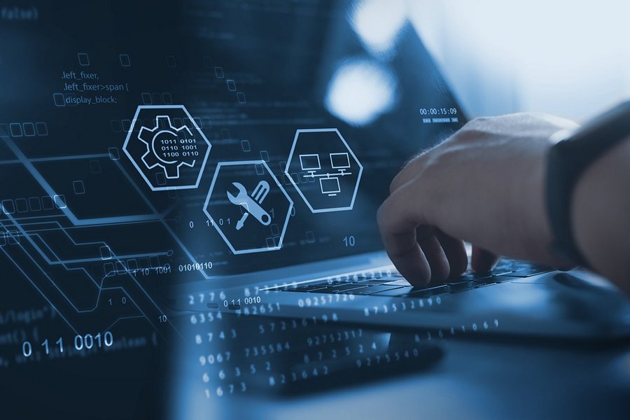 Technician works on laptop to manage database, big data and digital technologies.