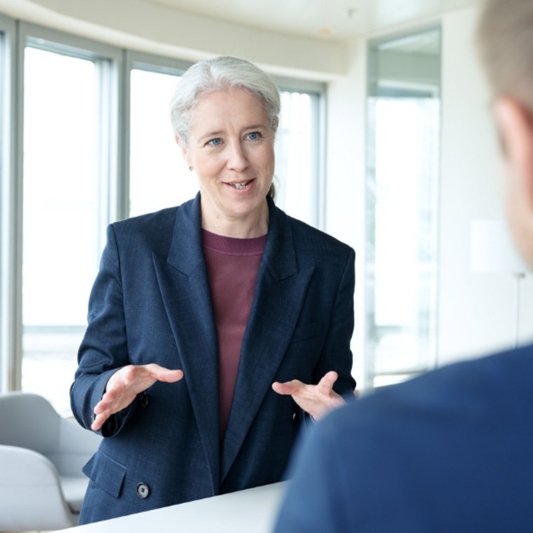 Gabrielle Bugat speaks about wallet and payment innovations in a modern, light-filled office.