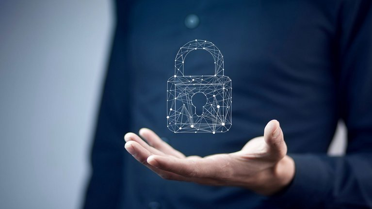 A man holding a symbol of a digital lock, symbolizing security or protection in the digital space..