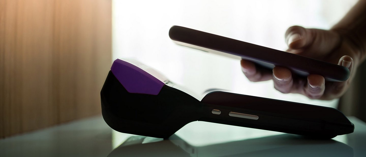 A close up of man using mobile digital payment