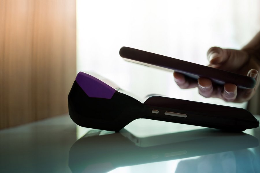 A close up of man using mobile digital payment