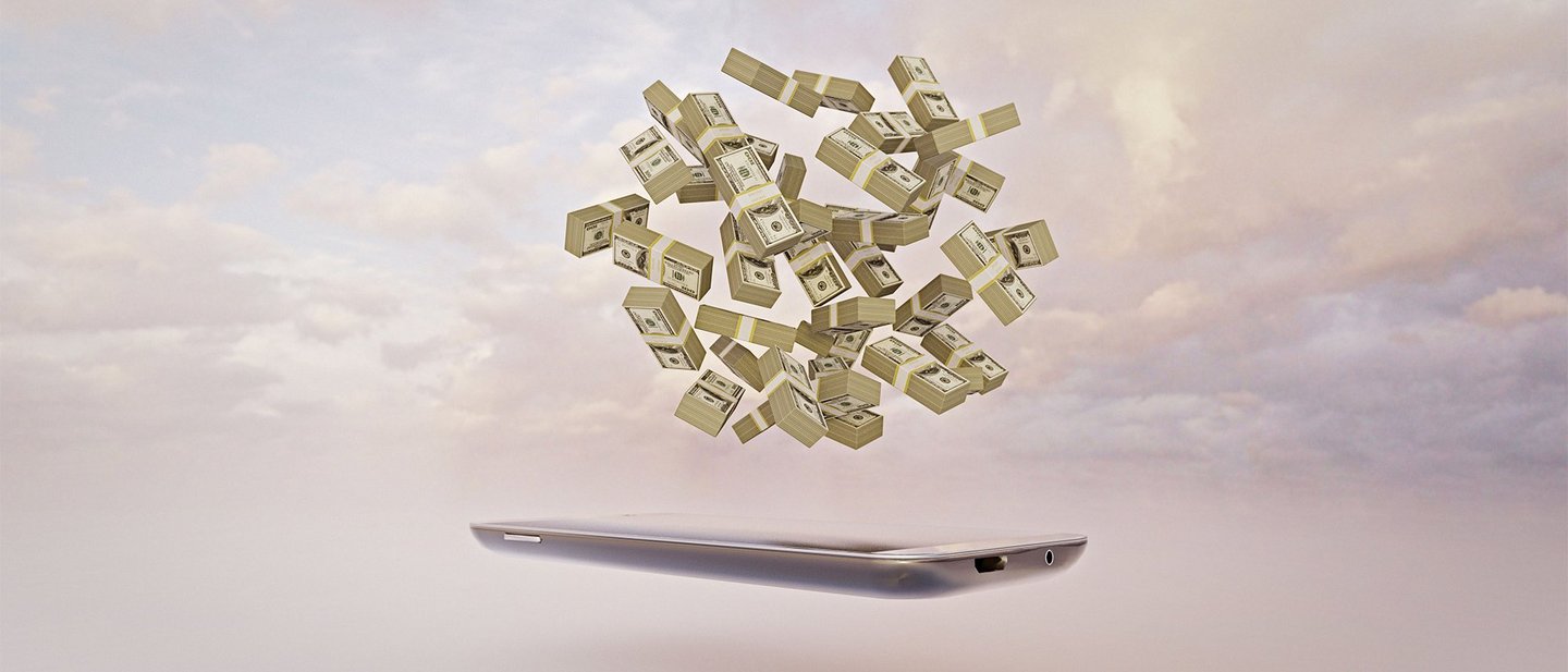 Bundles of cash floating in a ball over a mobile phone