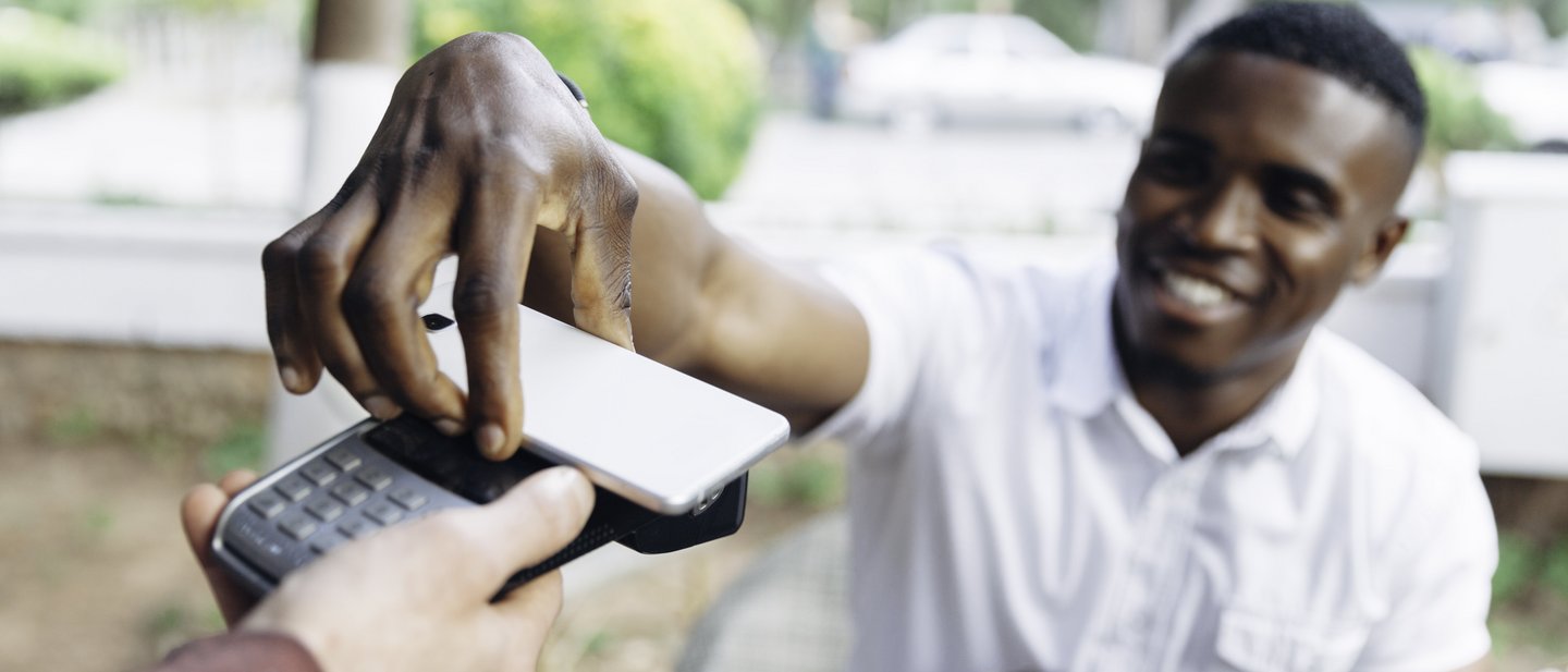A man uses his smartphone to pay
