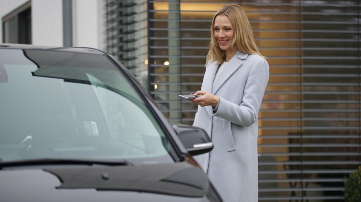Woman opens her car with her mobile