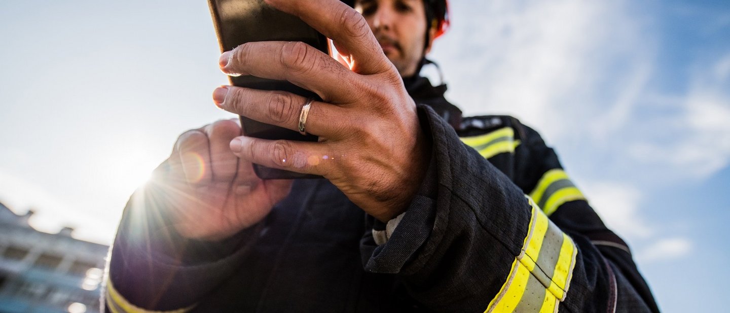Firefighter on duty with mobile phone
