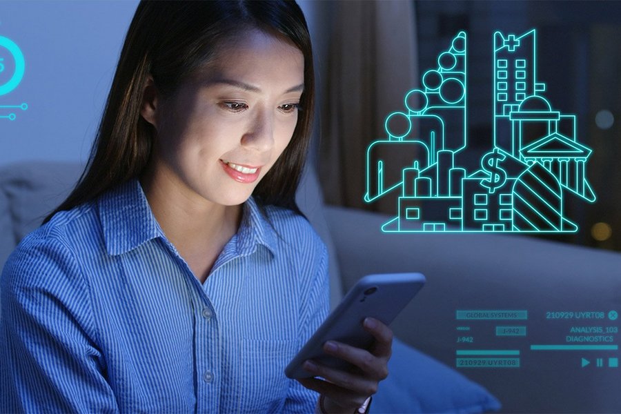 A woman looks at her smartphone screen, various digital icons and diagrams are shown