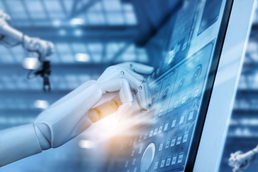 Robotic hand touching a screen and controlling robotic arms in the background represents hyperautomation.