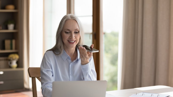 An elderly woman makes use of accessible payment options