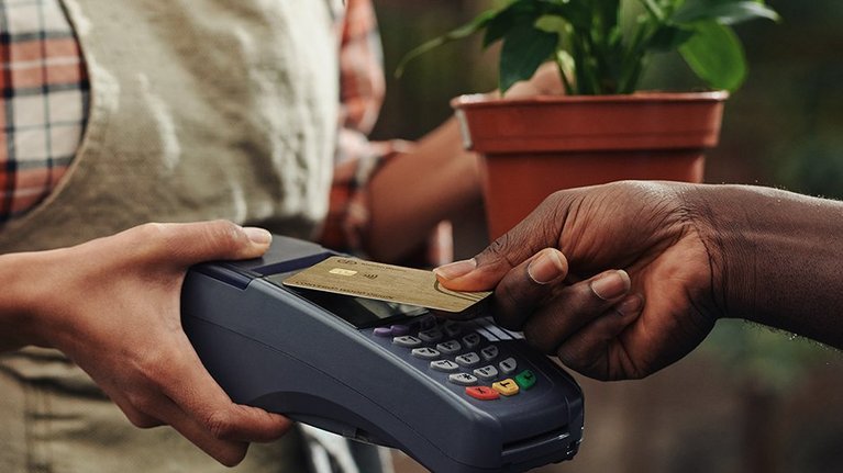 person using a wooden payment card during payment process