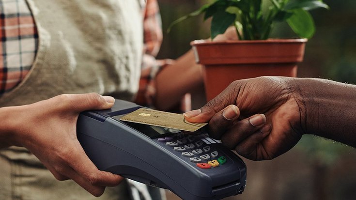 person using a wooden payment card during payment process