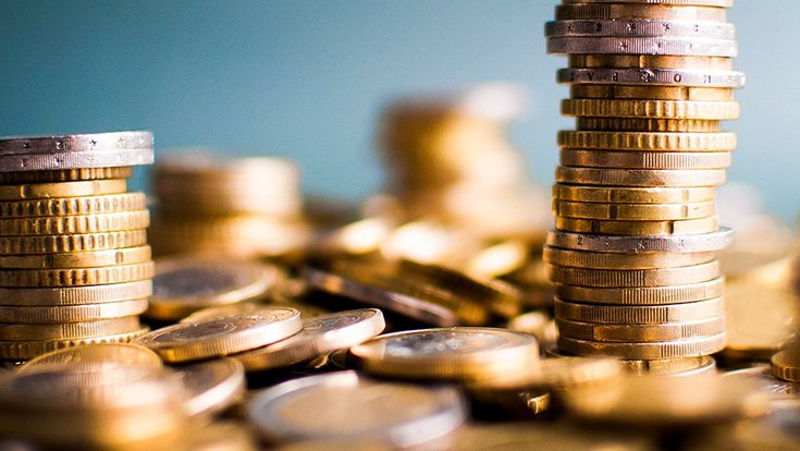 Two towers of euro money coins on a pile of other coins