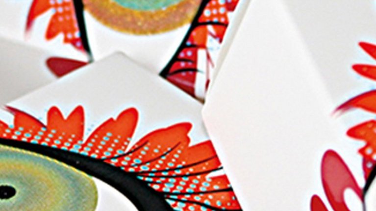 Three paper boxes each with an artfully depicted eye on it