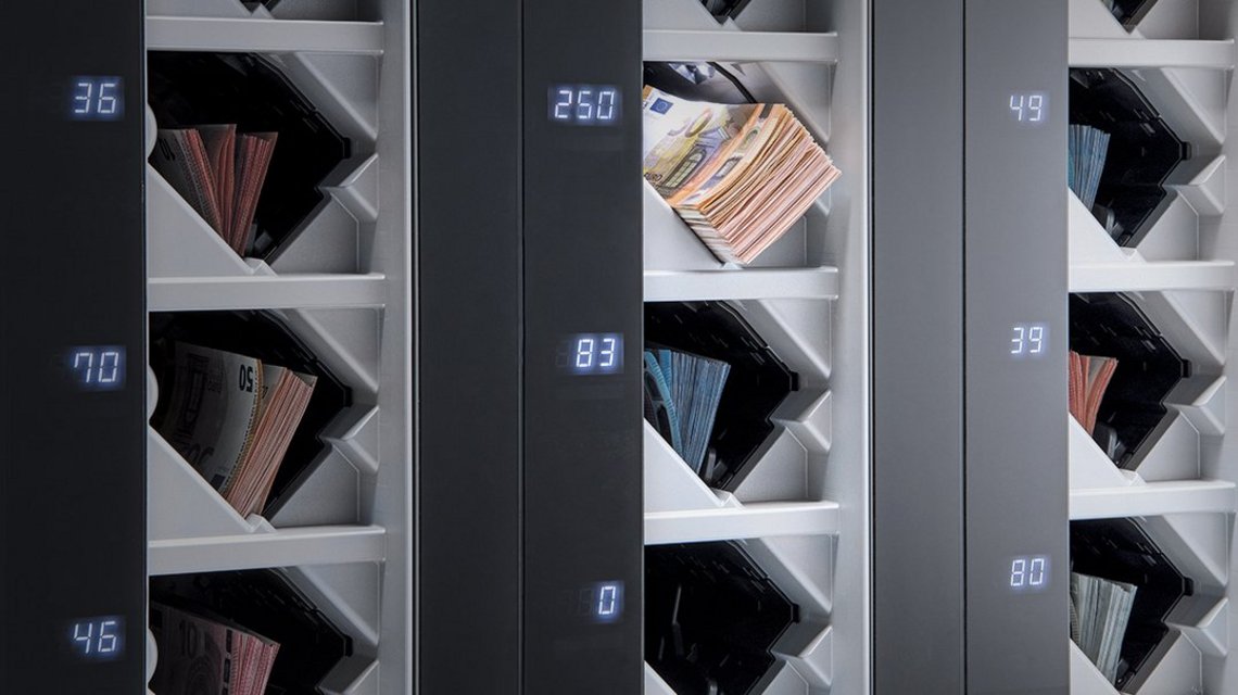 Output compartments of the BPS® C5 banknote processing system filled with euro banknotes sorted by denomination.