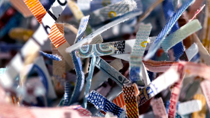 Close up of small snippets of shredded euro banknotes