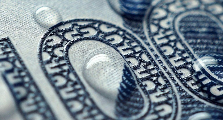 Close up of banknote with water drop