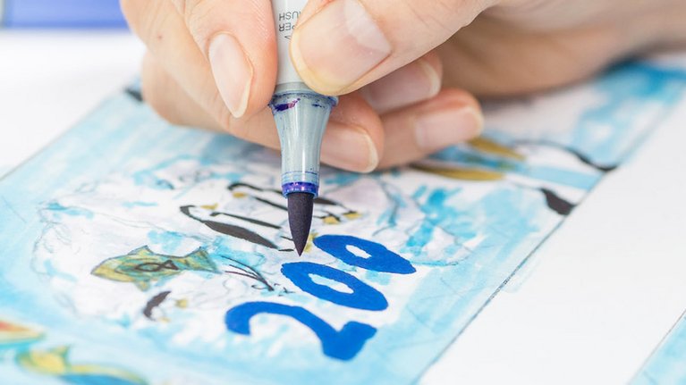 A designer designs a banknote with different motifs