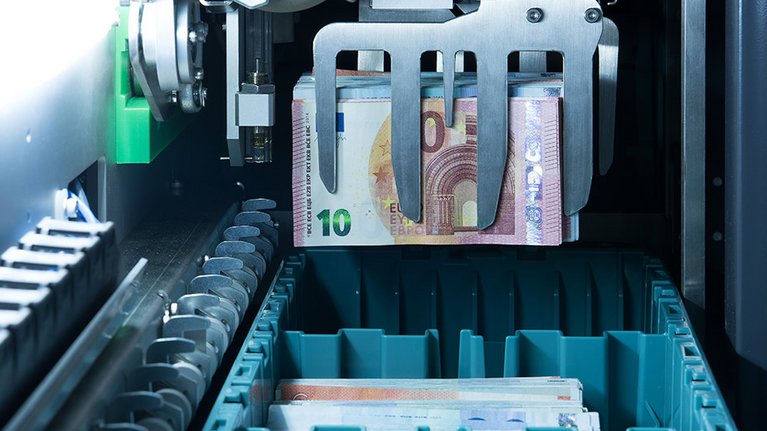 View of the inside of a machine through which banknotes pass