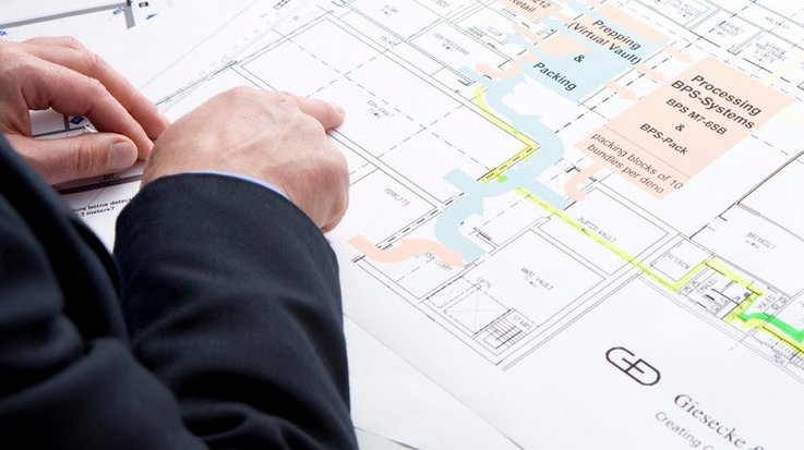 Finger pointing at floor plan of a building