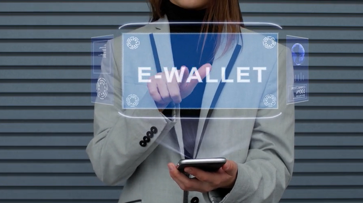 A woman uses the technology of an e-wallet on her mobile screen device.